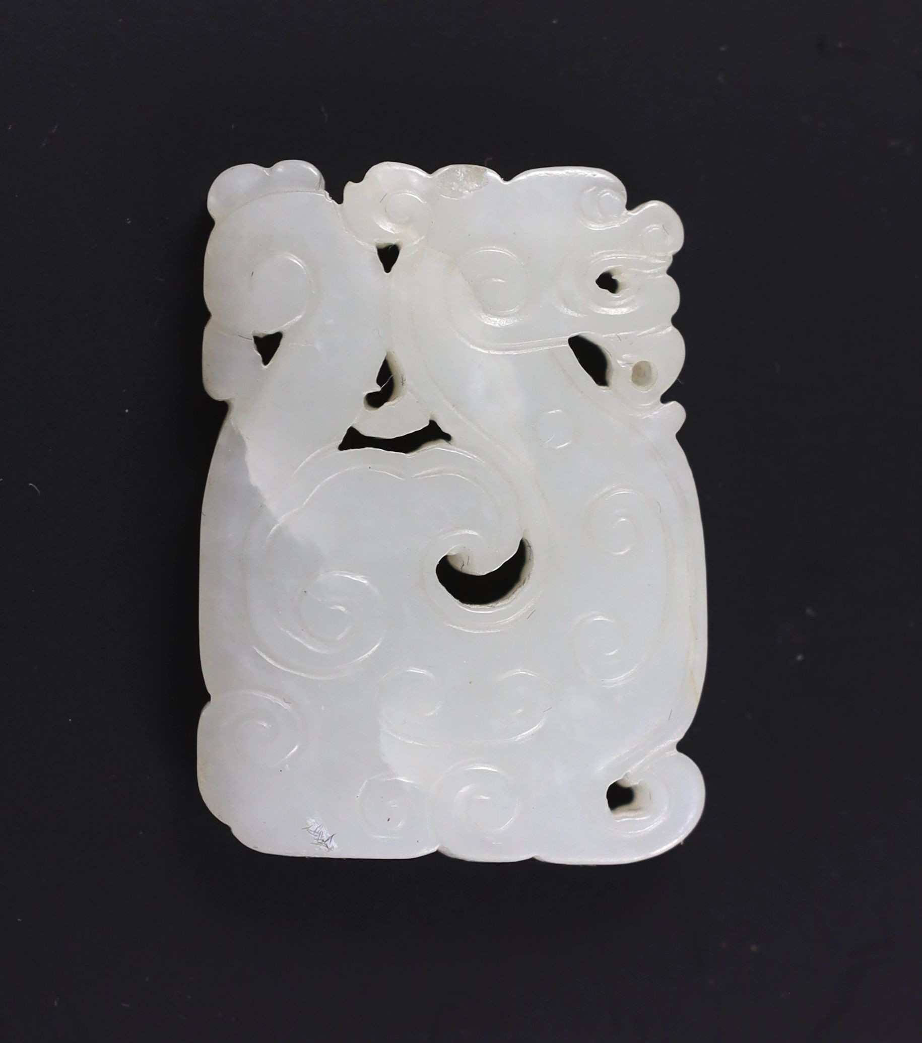 A Chinese white jade plaque, 19th century, 4.9cm, splinter chip, wood stand